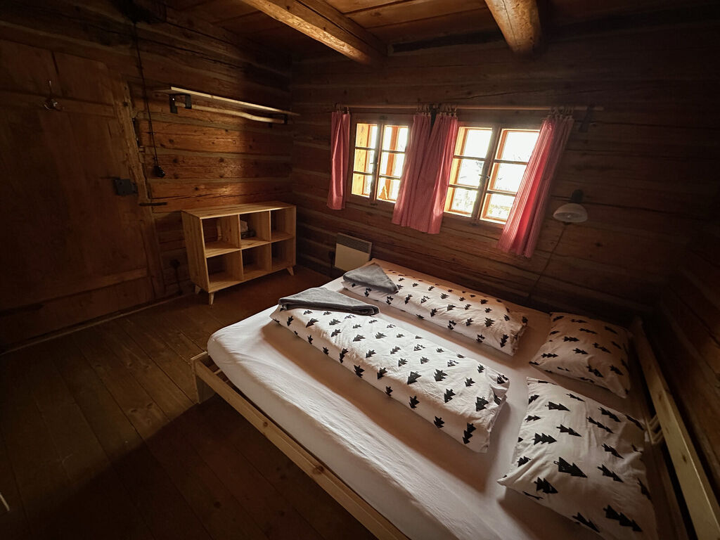 Ložnice se třemi postelemi a červenými závěsy